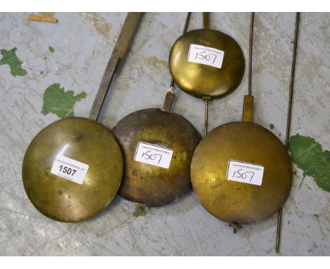 Group of four longcase clock pendulums and three weights 