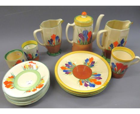 Two Clarice Cliff Crocus pattern octagonal jugs, coffee pot, mug, beaker, preserve pot and twelve various odd plates and sauc