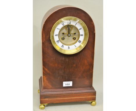 Mahogany dome shaped mantel clock, with brass dial, enamel chapter ring, Roman numerals, two train movement and visible escap