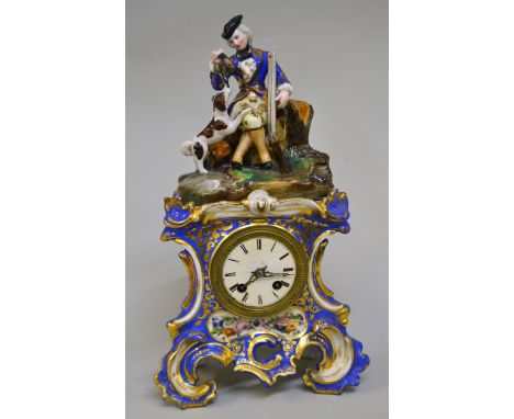 19th Century French porcelain mantel clock in Jacob Petit style, the rococo case surmounted by a figure of a sportsman with a