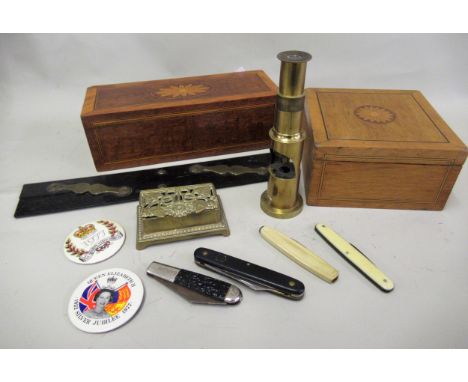 Late 19th / early 20th Century brass field microscope, brass double stamp box, four pen knives, an ebony brass mounted parall