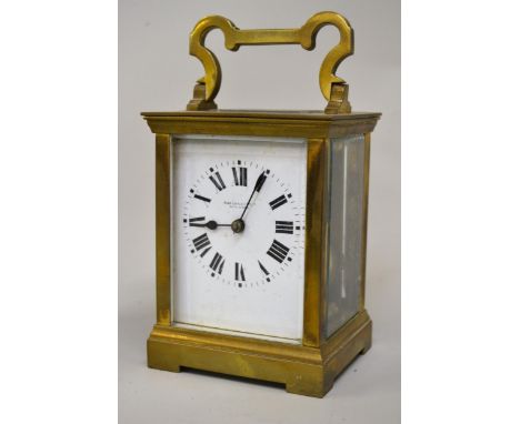 Brass cased carriage clock, the enamel dial with Roman numerals, signed John Little & Company, Singapore, the two train movem