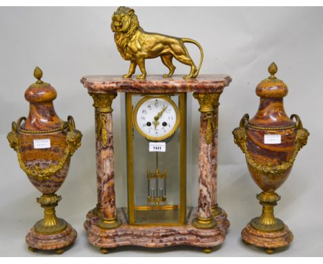 19th Century French pink flecked marble and ormolu mounted portico clock with lion surmount, the enamel dial with Arabic nume