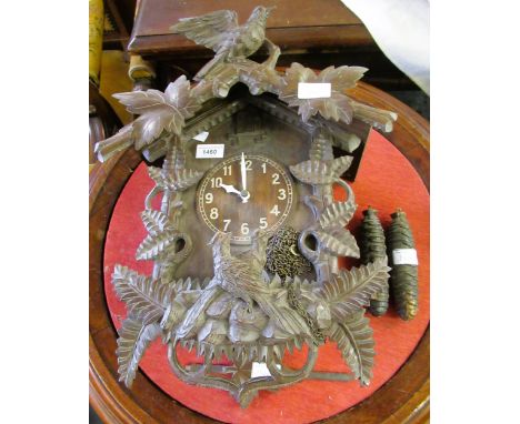 20th Century Black Forest carved cuckoo clock with a two train weight driven movement, 41cms high overall 