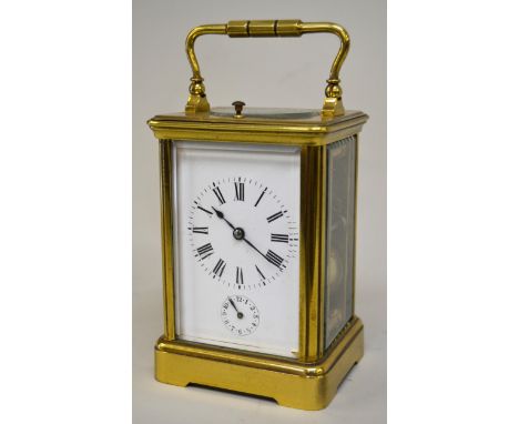 Early 20th Century brass cased carriage clock, the enamel dial with Roman numerals and subsidiary alarm dial, the two train m
