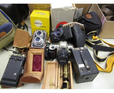 Cased student microscope, together with various cameras and related photographic accessories 