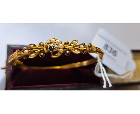 15ct Gold sapphire and split pearl bangle with a star, crescent and fleur de lis motif and Etruscan style shoulders, in the o