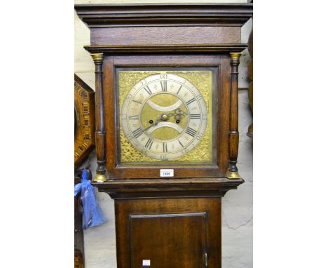 Late 18th Century oak longcase clock, the square hood with flanking pilasters above a rectangular panelled door and conformin