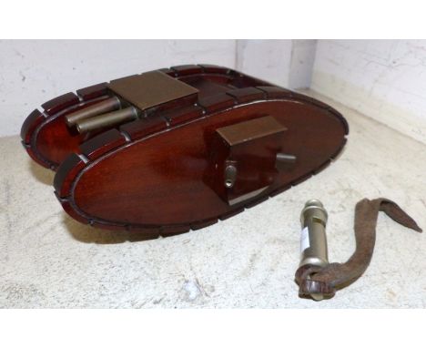 A mahogany and brass trench art model of a British tank made by a wound WW1 survivor and a trench whistle dated 1916