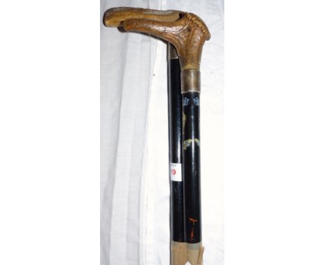 A horn handle walking stick with silver collar with lion transfer decoration and another similar