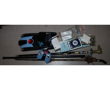 3 walking sticks, an Intercity telephone, toy cars, lighter etc.