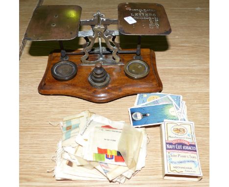 A set of brass postage scales with weights and a selection of silk and other cards; a vintage sewing machine