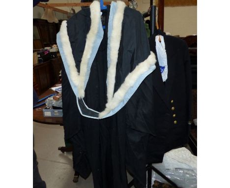 A Naval 2nd Lieutenant’s jacket and cap; a graduate gown with ermine sash and a girl's vintage school uniform