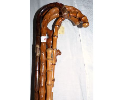 A cane swagger stick with crest, 3 cane sticks and 2 others