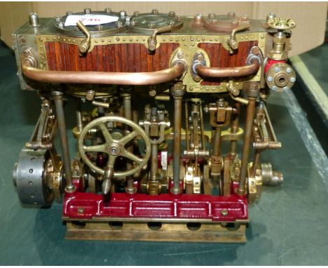 A scale model steam driven triple cylinder marine reciprocating engine