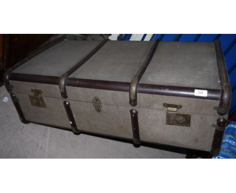 A fibre woven cabin trunk with metal bindings