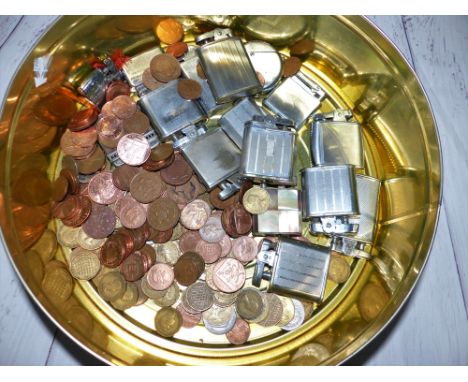 A selection of vintage petrol lighters, a quantity of coins