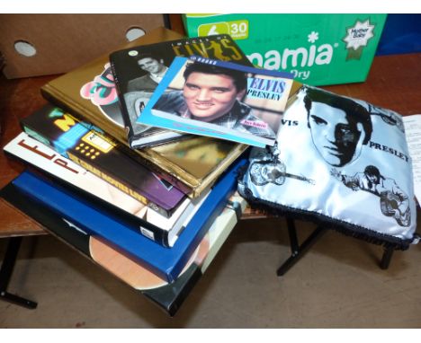 A selection of Elvis memorabilia including boxed set of Greatest Hits, books, calendar, plates, T shirt, wall hanging etc