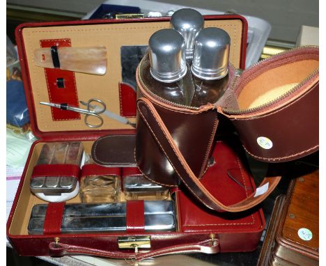 A gent's toilet set in fitted leather case; a triple bottle hip flask set in leather holder