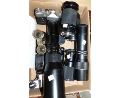 An Olympus SLR camera, other cameras and lenses