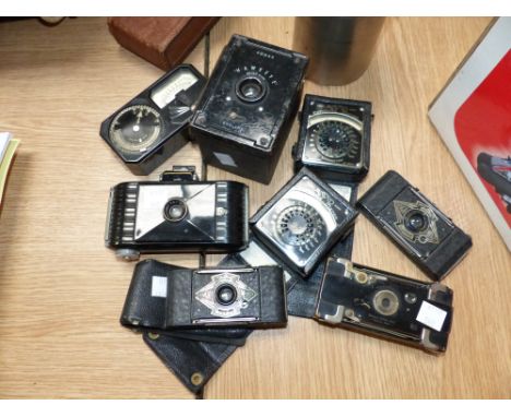 An Ensignette vest pocket camera, other similar period miniature cameras, 3 early light meters