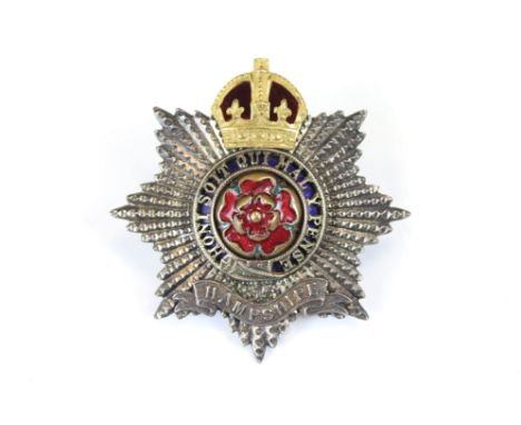 A British Military The Hampshire Regiment Kings Crown Cap Badge With Enamel Decoration, Complete With Twin Loop Fixings To Th