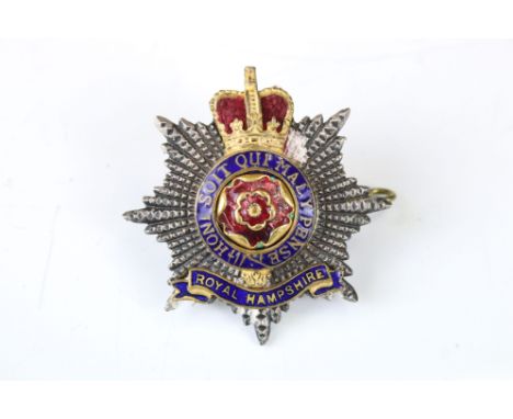 A British Military The Royal Hampshire Regiment Queens Crown White Metal Cap Badge With Enamel Decoration, Complete With Twin