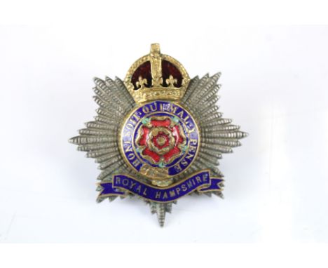 A British Military The Royal Hampshire Regiment Kings Crown White Metal Cap Badge With Enamel Decoration, Complete With Twin 