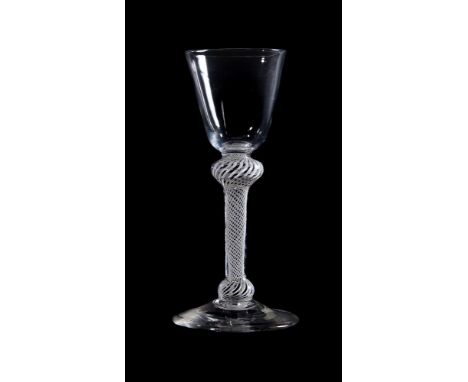 An opaque-twist wine glass, circa 1760, the round funnel bowl above a double-knopped stem filled with spiral threads, on a co