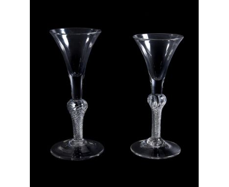 Two similar composite stemmed wine glasses, mid 18th century, of drawn trumpet form and with inverted baluster airtwist stems