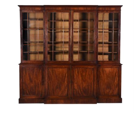 A Regency mahogany library bookcase, circa 1815, of breakfront outline, the moulded cornice above glazed bookcase doors, the 