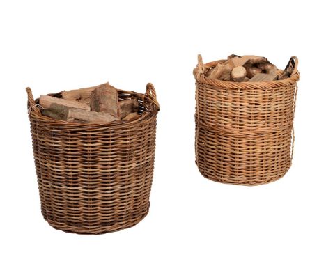 Two similar twin handled wicker baskets, presented as log baskets, each approximately 67cm high, together with a set of three