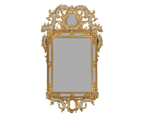 A Continental gilt wood wall mirror, late 18th/early 19th century, the foliate carved frame with mirrored panels, 148cm high,