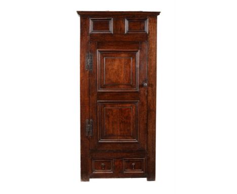 An oak cupboard, early 18th century, the panel moulded door opening to a shelved interior, 166cm high, 81cm wide, 48cm deep C