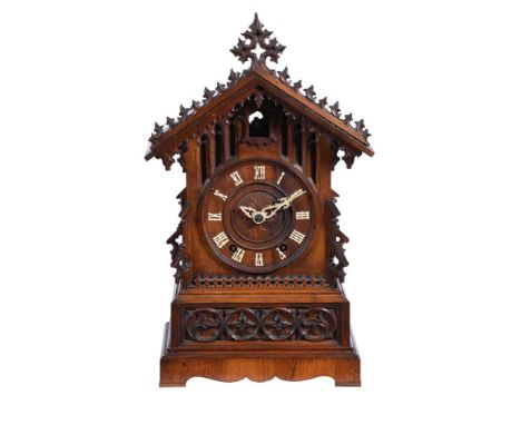 A carved oak and pine mantel clock of Black Forest type, circa 1900, with architectural gothic case, the eight day two-train 