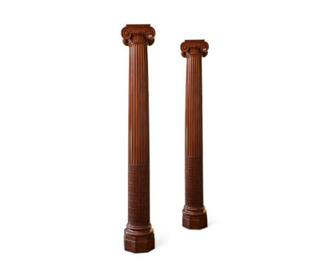 A pair of large carved, stripped cedar columns, of ionic order, each 279cm highProvenance: Previously from a Private Collecti