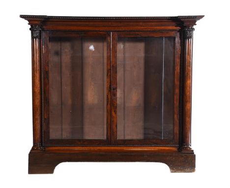 Y A rosewood side cabinet, circa 1835 and later, in the manner of Gillows, with a pair of glazed doors enclosing a glass shel