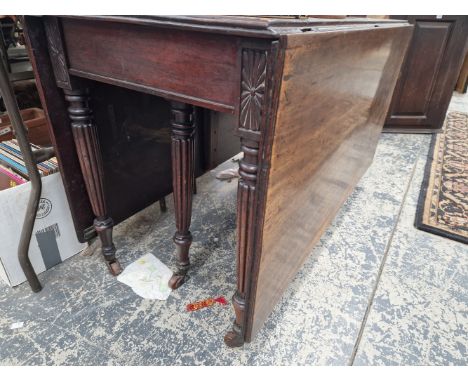 A 19th C. MAHOGANY DROP FLAP DINING TABLE ON REEDED LEGS TAPERING TO CERAMIC CASTER FEET.