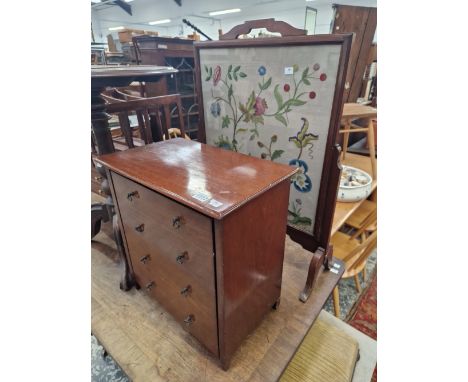 A MAGAZINE RACK AND A FIRE SCREEN