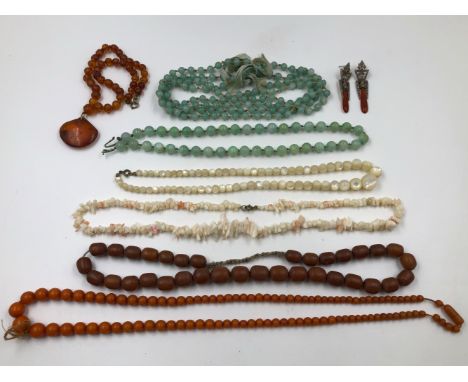 A FACETED AMBER BEADED NECKLACE WITH A LARGE SINGLE PENDANT DROPPER WITH GOLD MOUNT OF INSECT INCLUDED AMBER ,TWO VINTAGE STR
