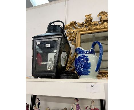 A LARGE CARRIAGE LANTERN AND AN IRONSTONE TYPE BLUE AND WHITE JUG. 