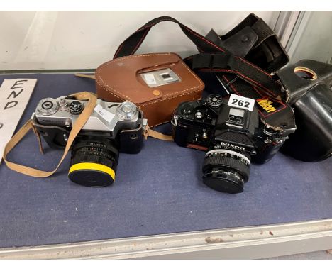 A ZENIT EM CAMERA TOGETHER WITH A NIKON SLR CAMERA AND A CINE CAMERA. 