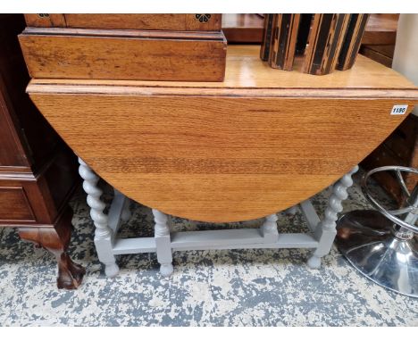 AN OAK GATE LEGGED TABLE WITH PAINTED BASE 