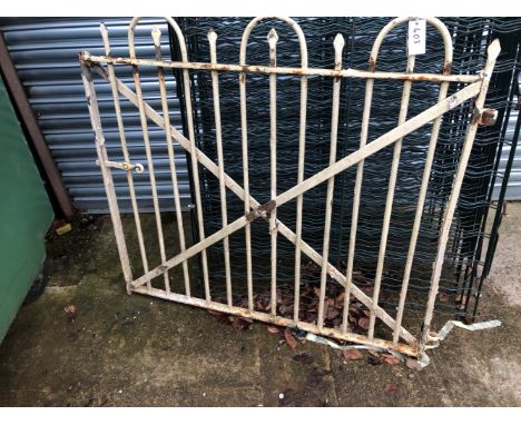 A WHITE PAINTED IRON GARDEN GATE