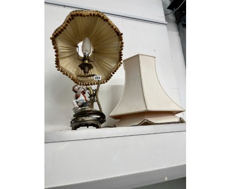 A GILT BRASS LAMP WITH PORCELAIN FIGURE. 