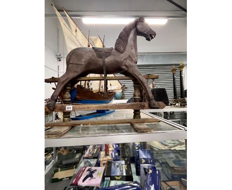 A VINTAGE INFANT SIZED WOODEN ROCKING HORSE. 