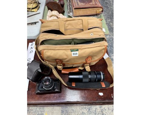 AN OLYMPUS OM-1 CAMERA, CARRYING BAG WITH ACCESSORIES AND LENSES TO INCLUDE A ZUIKO MC AUTO-ZOOM LENS