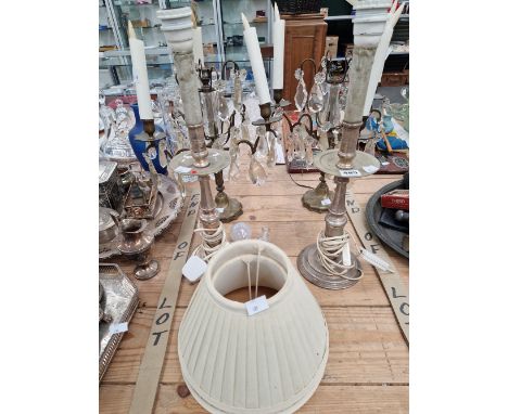 A PAIR OF THREE LIGHT CANDELABRA HUNG WITH GLASS DROPS TOGETHER WITH A PAIR OF SILVERED METAL CANDLESTICK LAMPS