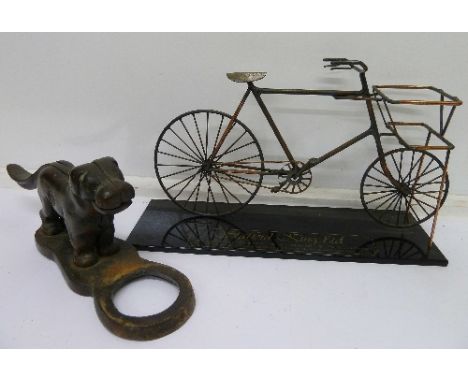A cast metal nutcracker in the form of a dog and a Stafford King bicycle advertising sign