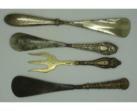 Three silver handled shoe horns and a fork